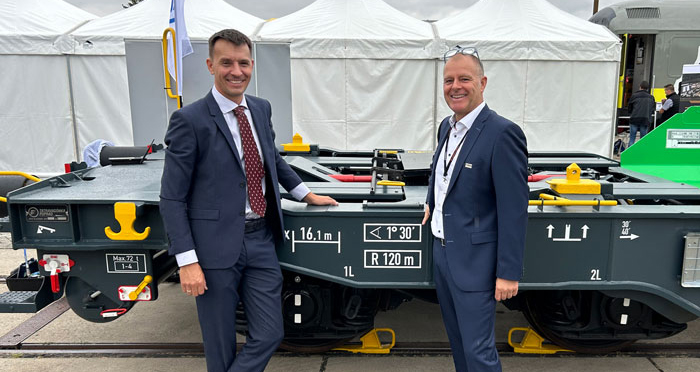 At InnoTrans in Berlin, Felix Egger-Cimenti, Project Manager at PJM, and Markus Degasperi, Managing Director of Trafag Austria, celebrate their successful collaboration in shaping the future of rail freight transport.